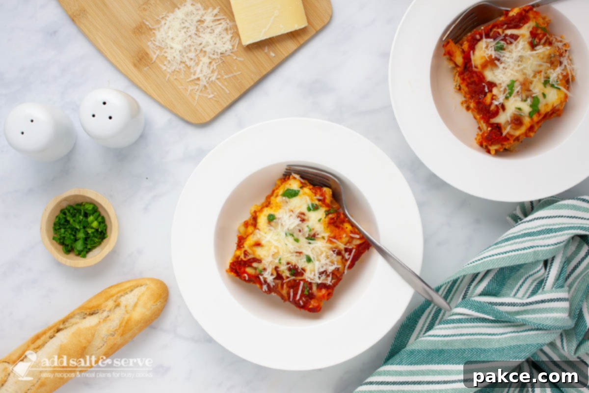 Classic Cheesy Meatless Baked Ziti 10 Bowl of cheesy meatless baked ziti garnished with fresh parsley and grated Parmesan cheese.