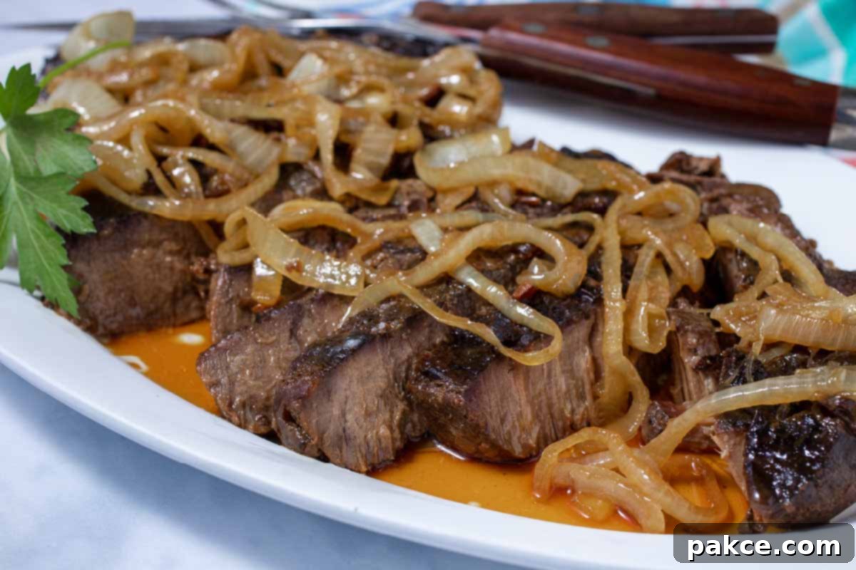 Tender Crockpot London Broil Au Jus 8 Perfectly sliced crock pot London Broil with au jus, garnished with tender onions and fresh herbs, ready to serve.