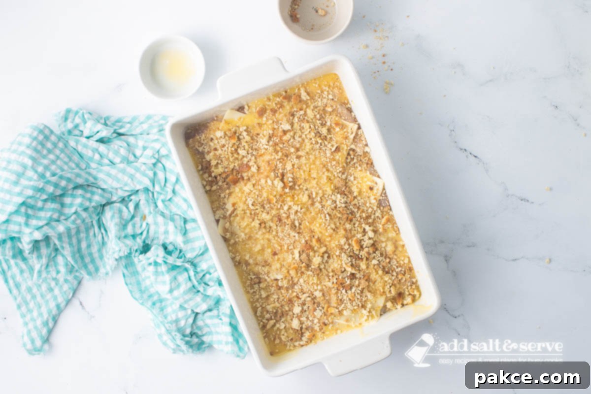 Baked Swiss Chicken with White Wine 9 Casserole dish of Swiss chicken with white wine and stuffing before baking.