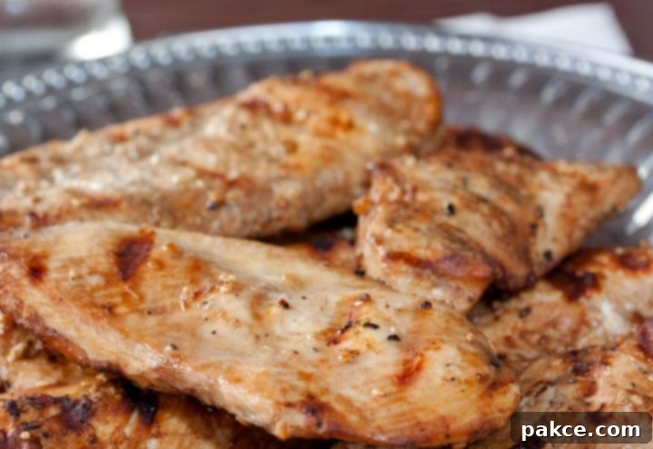 Grilled boneless skinless chicken breasts with a sesame marinade brushed on them and served on a Armetale platter