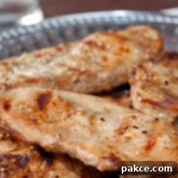 Crispy Sesame Chicken 2 Grilled boneless skinless chicken breasts with a sesame marinade brushed on them and served on a Armetale platter