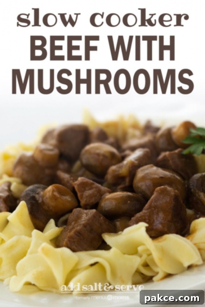 slow-cooker-beef-mushrooms-pin-min White plate with egg noodles topped with slow cooker beef and mushrooms, garnished with a sprig of fresh parsley. Text overlay: Slow Cooker Beef with Mushrooms - Add Salt & Serve (formerly Menus4Moms). Ideal for easy weeknight dinners, freezer cooking, and family meals.