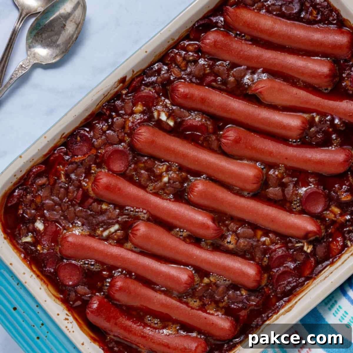 Delicious baked franks and beans in a rustic baking dish, ready to serve.
