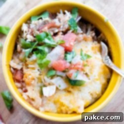 Spicy Tex-Mex Beef Bake 3 Close-up of a Tex-Mex Beef Casserole, showing the layers of beef, rice, beans, and melted cheese, topped with fresh cilantro.