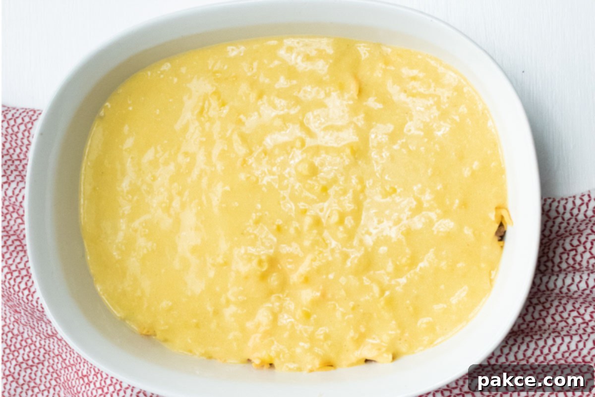 Hearty Cornbread Burger Bake 5 White casserole dish with a topping of cornbread batter