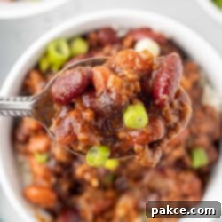30-Minute BBQ Beef and Beans 7 Spoonful of beef and beans garnished with green onion.