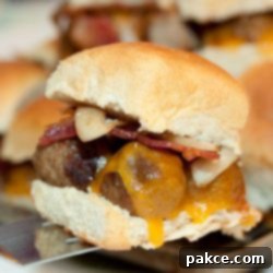 Smoky BBQ Meatball Sliders 3 Hawaiian roll with meatballs, melted cheddar cheese, bacon, and sautéed onions