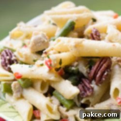 Gourmet Chicken Asparagus Salad with Pecans 3 Asparagus Chicken Salad on a green and white plate.