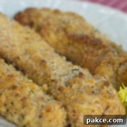 Garlic Parmesan Baked Chicken Strips 3 Three breaded chicken tenders on white plate
