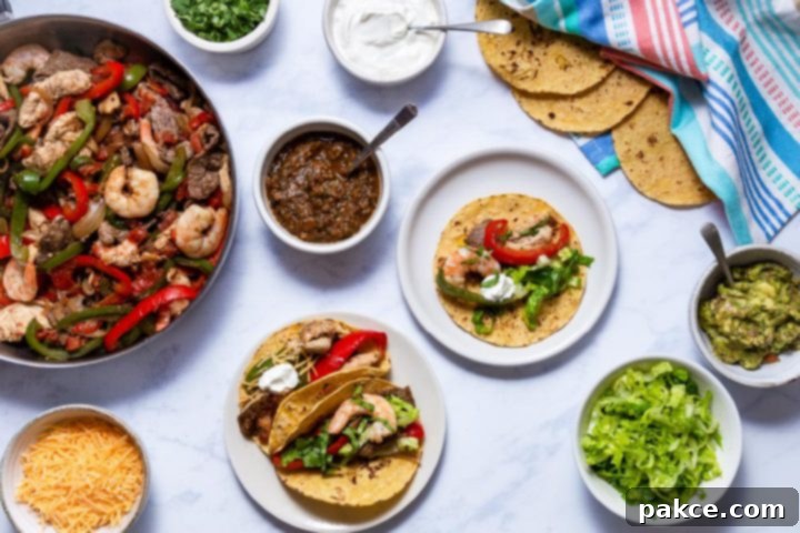 Texas Fajitas 4 Beautifully arranged prepared Texas Fajitas with beef, chicken, and shrimp, served on warm tortillas with an assortment of fresh toppings including guacamole, cheese, lettuce, sour cream, cilantro, and salsa.