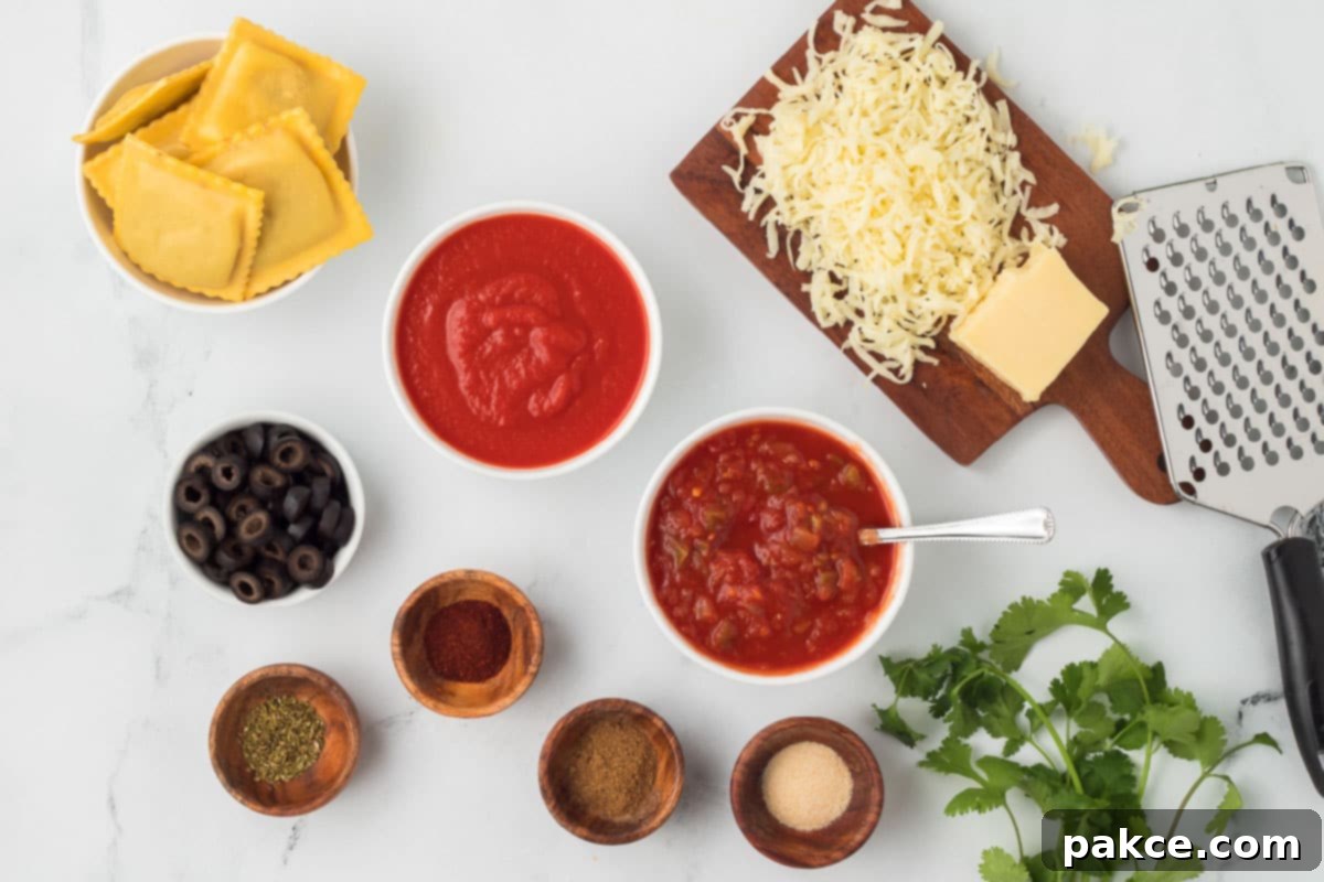 Fiesta Ravioli 3 A selection of fresh ingredients laid out for Mexican Ravioli, including beef ravioli, salsa, Monterey Jack cheese, black olives, tomato sauce, dried oregano, garlic powder, chili powder, onion powder, and ground cumin.