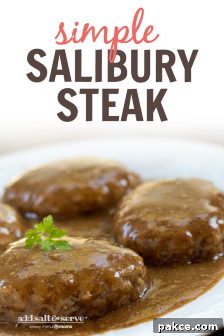 Simple Salisbury Steak A close-up shot of a single Salisbury Steak patty drenched in savory brown gravy, garnished with fresh parsley on a white plate.