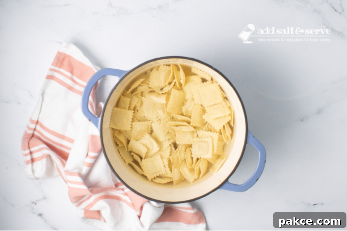 20-Minute Velvety Summer Squash Ravioli 4 Dutch oven of cheese ravioli in water.