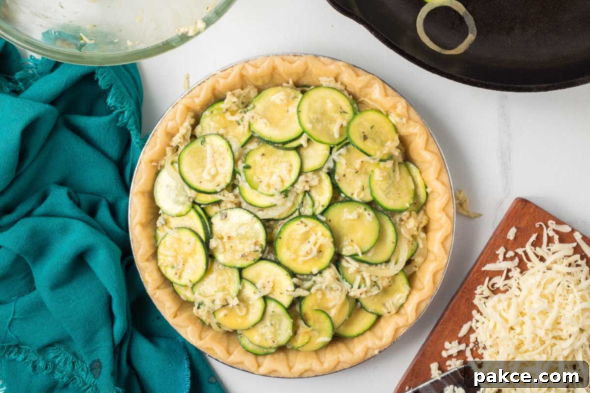 Golden Zucchini Cheese Quiche 6 The prepared quiche filling (sautéed zucchini, onion, cheese, herbs, and egg) poured into the pie crust.
