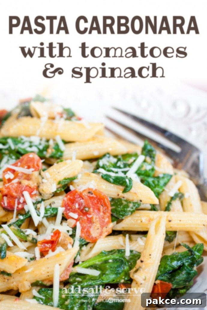 White plate with penne pasta, cooked baby spinach, cherry tomatoes, and shredded mozzarella cheese. There is a fork on the plate; text pasta carbonara with tomatoes & spinach add salt & serve formerly menus4moms