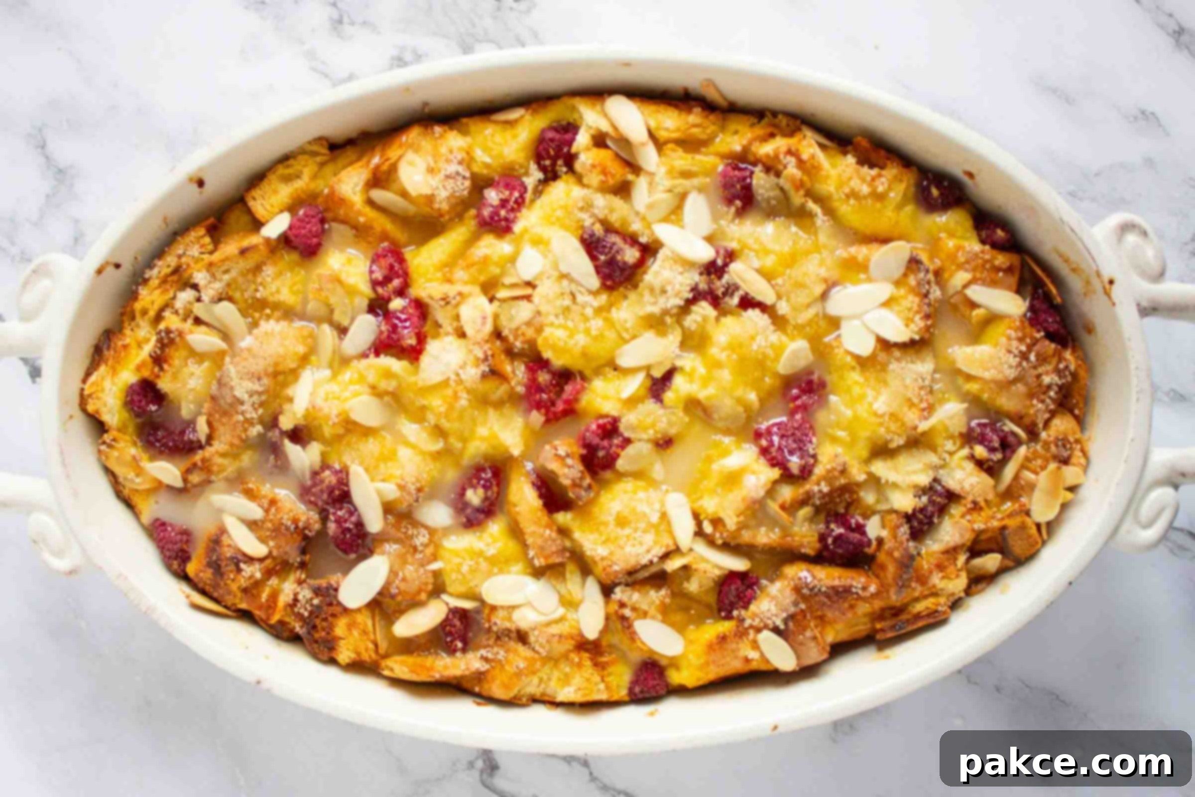 French toast bake with berries and almonds in a casserole dish.